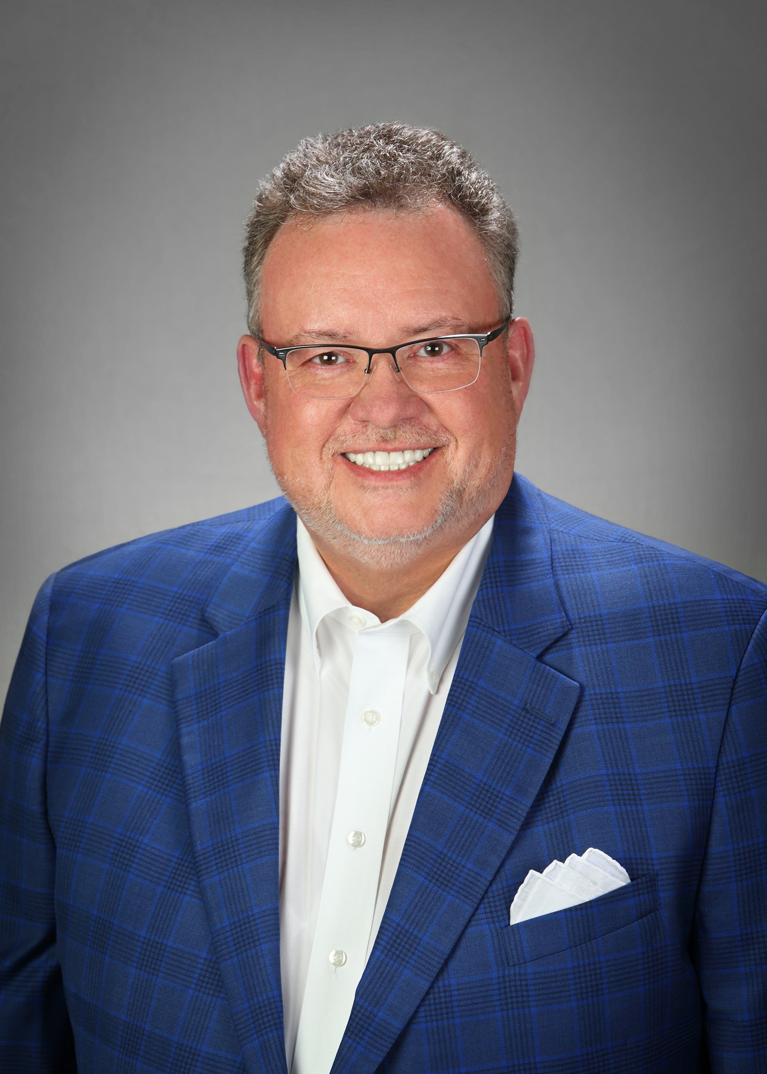 Brian Hale Headshot_Blue Suit Glasses